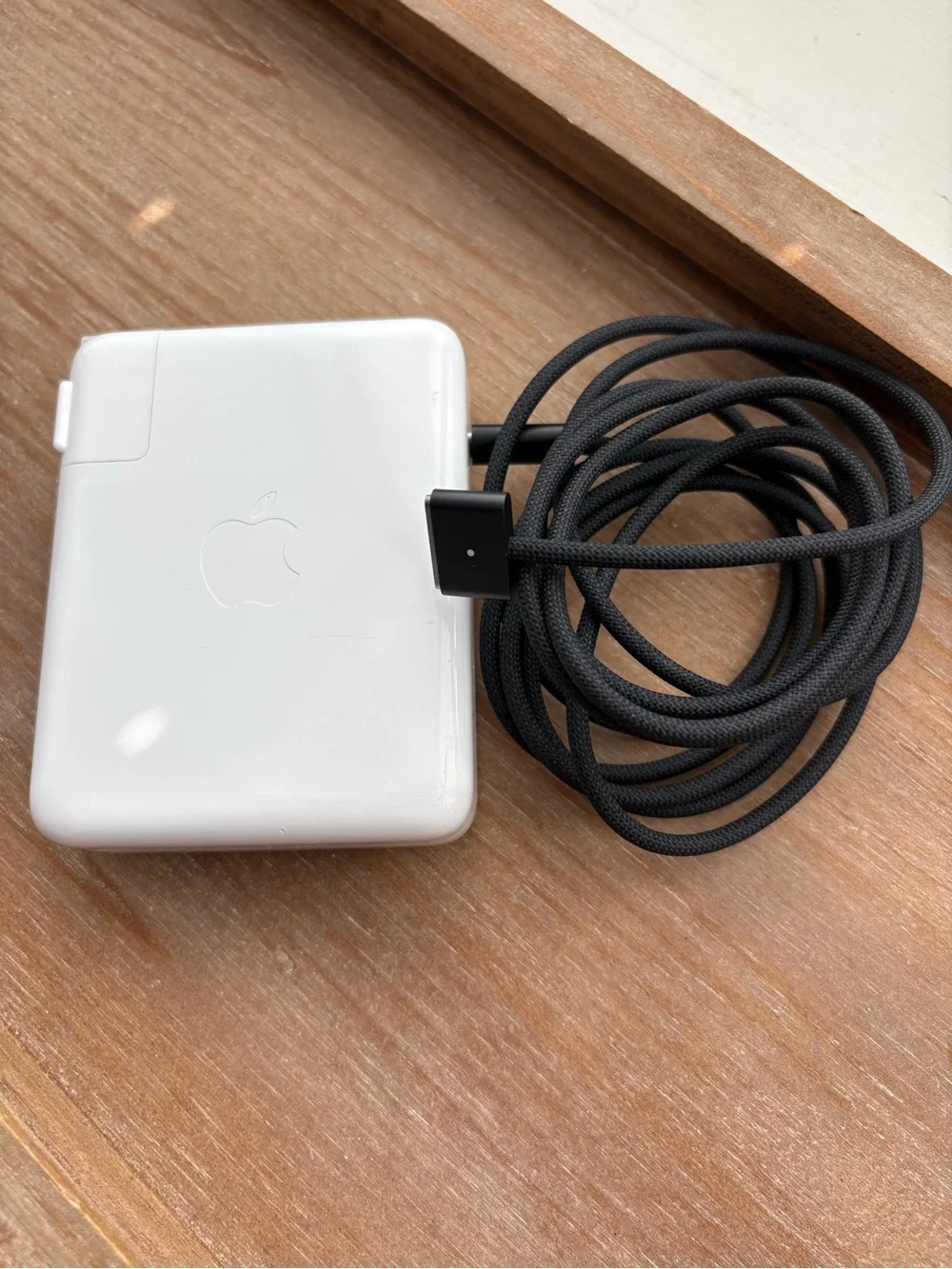 Apple 140w USB-C power adapter and black USB-C to MagSafe charging cord